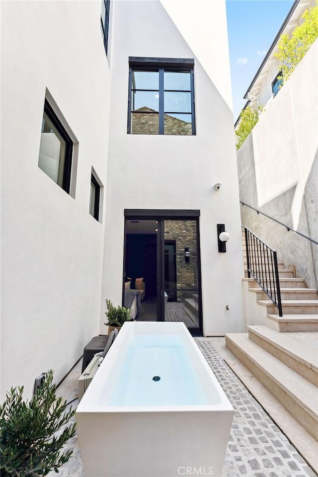 1831 Newport Hills Dr E, Newport Beach, CA 92660 - rear view of house featuring a jacuzzi and stucco siding
