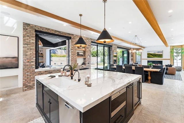 1831 Newport Hills Dr E, Newport Beach, CA 92660 - kitchen featuring stainless steel appliances, beam ceiling, a lit fireplace, open floor plan, and recessed lighting
