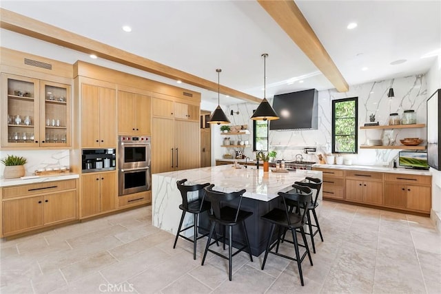 1831 Newport Hills Dr E, Newport Beach, CA 92660 - kitchen with stainless steel double oven, wall chimney exhaust hood, beamed ceiling, a large island with sink, and light stone counters