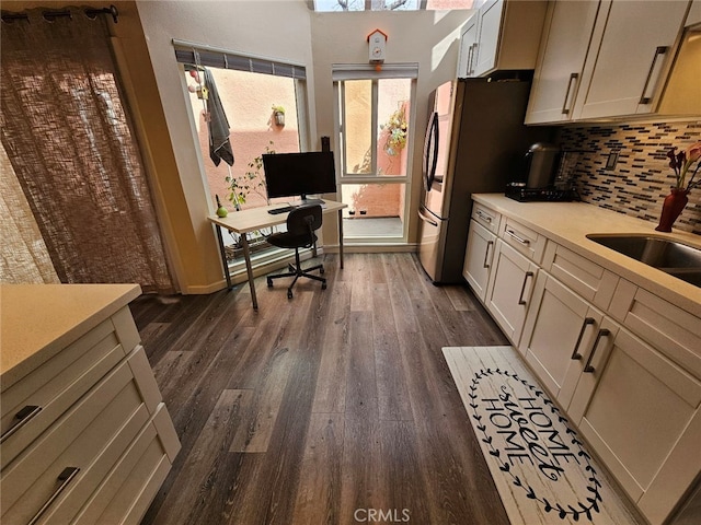 400 Monterey Rd Unit 10, Glendale, CA 91206 - kitchen featuring dark wood-style floors, decorative backsplash, light countertops, an office area, and freestanding refrigerator