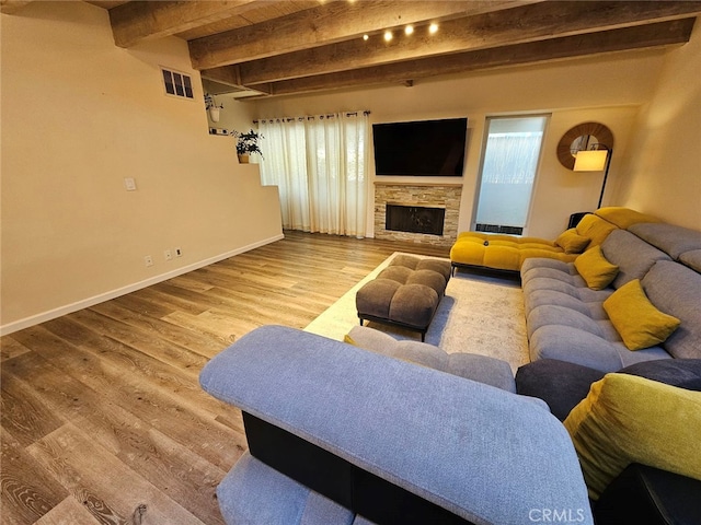 400 Monterey Rd Unit 10, Glendale, CA 91206 - living room featuring beam ceiling, wood finished floors, and a fireplace
