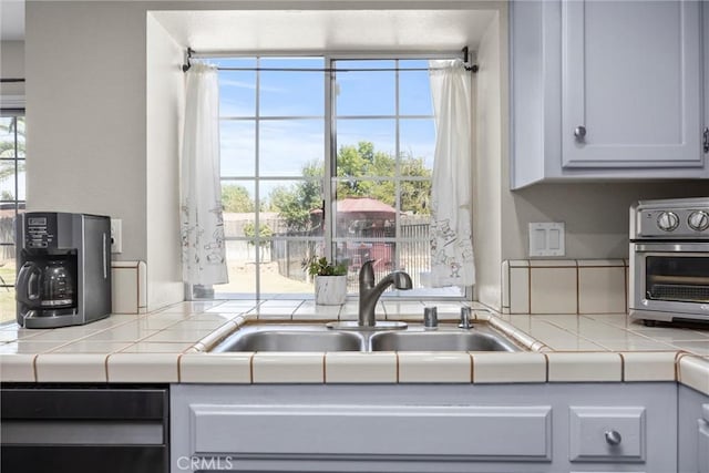 3108 Holbrook St, Bakersfield, CA 93312 - kitchen with tile counters and dishwashing machine