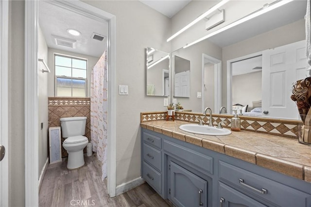 3108 Holbrook St, Bakersfield, CA 93312 - full bath featuring wood finished floors, vanity, tile walls, and a shower with shower curtain