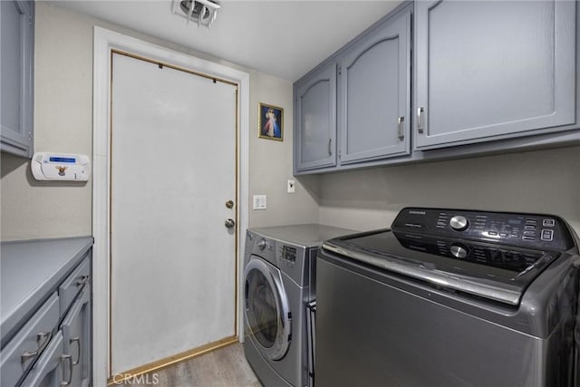 3108 Holbrook St, Bakersfield, CA 93312 - laundry room with cabinet space, light wood-type flooring, and washing machine and dryer