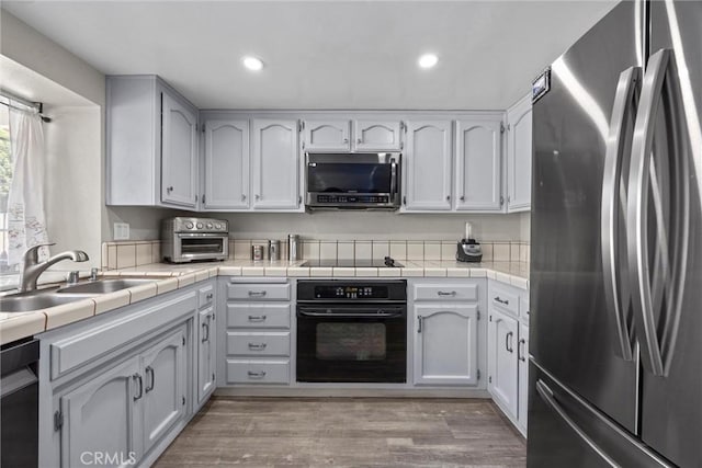 3108 Holbrook St, Bakersfield, CA 93312 - kitchen featuring black appliances, recessed lighting, white cabinetry, and light wood-style floors