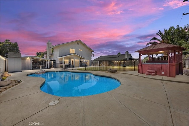3108 Holbrook St, Bakersfield, CA 93312 - pool at dusk with a patio area, a gazebo, a hot tub, and a fenced backyard