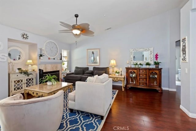 6939 Fremontia Ave, Fontana, CA 92336 - living area with a ceiling fan, a tiled fireplace, wood finished floors, and vaulted ceiling
