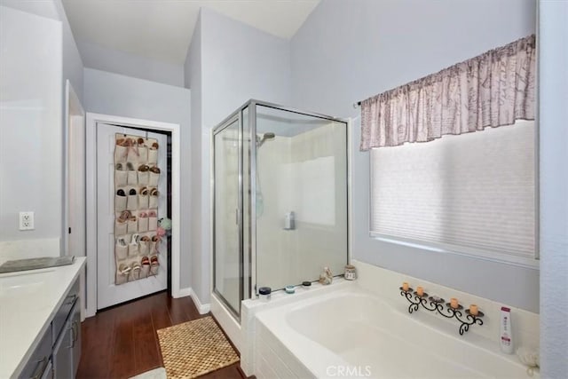 6939 Fremontia Ave, Fontana, CA 92336 - full bath featuring a stall shower, a garden tub, vanity, and wood finished floors