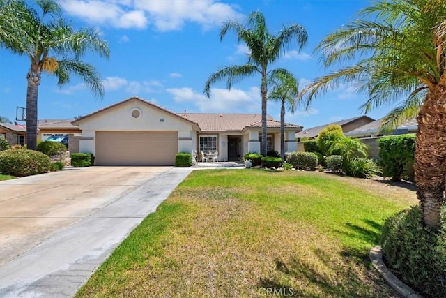6939 Fremontia Ave, Fontana, CA 92336 - view of front of house with stucco siding, a garage, concrete driveway, a front lawn, and a tiled roof