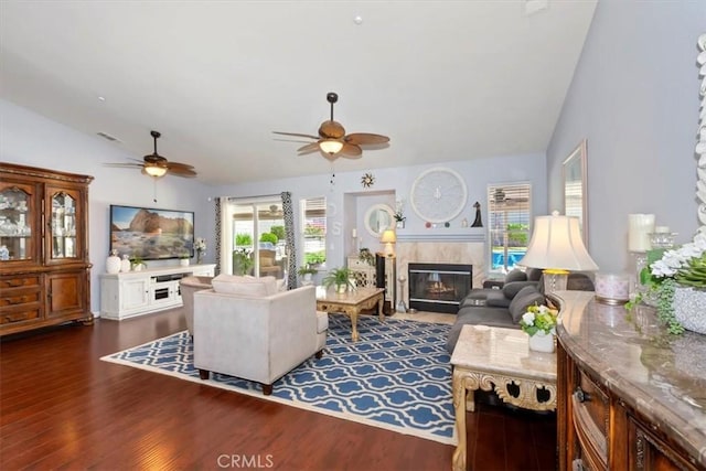 6939 Fremontia Ave, Fontana, CA 92336 - living room featuring lofted ceiling, ceiling fan, a fireplace with flush hearth, and dark wood-style flooring