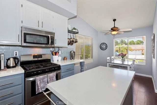 6939 Fremontia Ave, Fontana, CA 92336 - kitchen featuring appliances with stainless steel finishes, a ceiling fan, decorative backsplash, white cabinetry, and light countertops