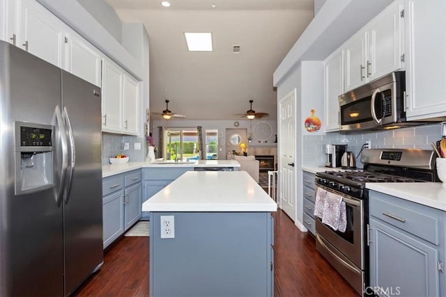 6939 Fremontia Ave, Fontana, CA 92336 - kitchen with stainless steel appliances, a peninsula, ceiling fan, vaulted ceiling, and light countertops
