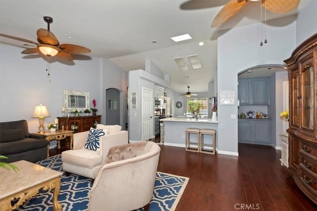 6939 Fremontia Ave, Fontana, CA 92336 - living room with ceiling fan, arched walkways, dark wood finished floors, and lofted ceiling