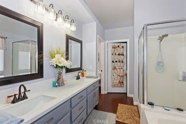 6939 Fremontia Ave, Fontana, CA 92336 - bathroom featuring double vanity, a shower stall, wood finished floors, and a tub to relax in