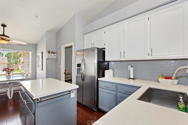 6939 Fremontia Ave, Fontana, CA 92336 - kitchen with dark wood finished floors, stainless steel refrigerator with ice dispenser, tasteful backsplash, white cabinetry, and light countertops