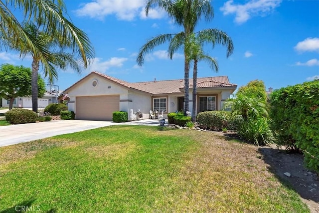 6939 Fremontia Ave, Fontana, CA 92336 - view of front of home with stucco siding, an attached garage, driveway, a tiled roof, and a front lawn