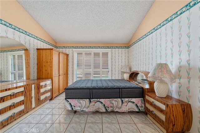 22533 Kinross Ln, Moreno Valley, CA 92557 - bedroom with vaulted ceiling, a textured ceiling, light tile patterned flooring, wallpapered walls, and arched walkways