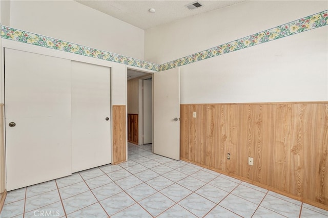 22533 Kinross Ln, Moreno Valley, CA 92557 - unfurnished room with wainscoting, wood walls, and a textured ceiling