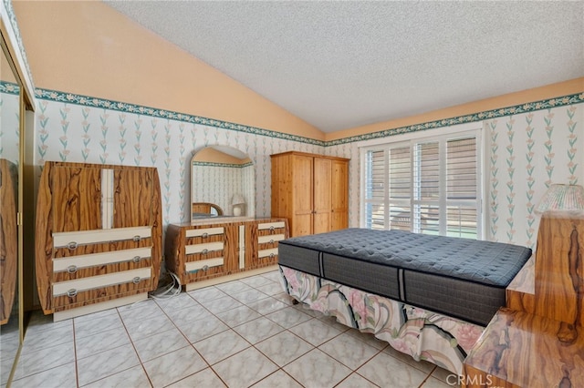 22533 Kinross Ln, Moreno Valley, CA 92557 - bedroom featuring lofted ceiling, a textured ceiling, wallpapered walls, and light tile patterned floors