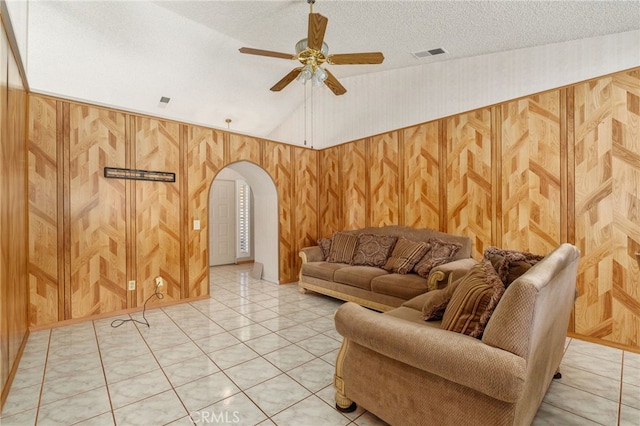 22533 Kinross Ln, Moreno Valley, CA 92557 - living area with ceiling fan, arched walkways, wood walls, lofted ceiling, and light tile patterned flooring