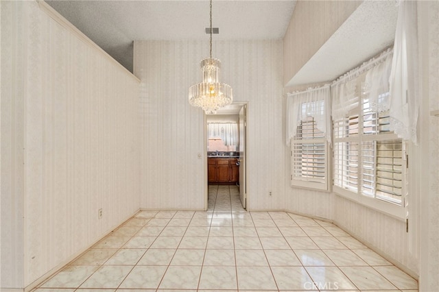22533 Kinross Ln, Moreno Valley, CA 92557 - unfurnished dining area with wallpapered walls, a chandelier, a textured ceiling, and light tile patterned flooring