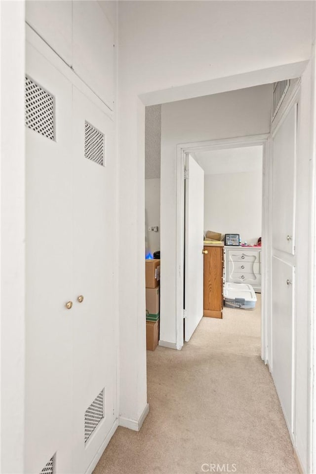 6186 Abronia Ave Unit 29, Palms, CA 92277 - hallway featuring light carpet and baseboards