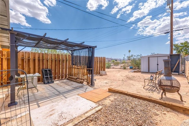 6186 Abronia Ave Unit 29, Palms, CA 92277 - view of yard featuring a fire pit, a storage unit, and a patio