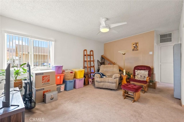 6186 Abronia Ave Unit 29, Palms, CA 92277 - living area with carpet flooring, a ceiling fan, and a textured ceiling