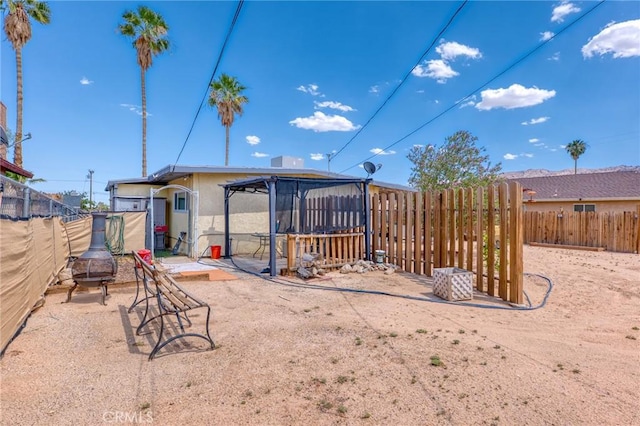 6186 Abronia Ave Unit 29, Palms, CA 92277 - rear view of property featuring a fenced backyard and stucco siding