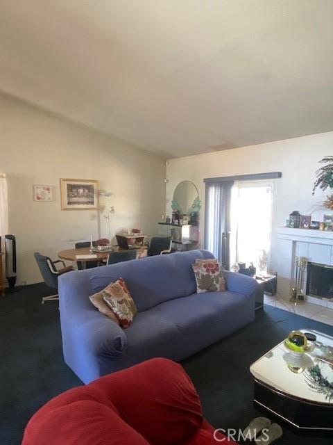 14310 Northstar Ave, Victorville, CA 92392 - carpeted living room with vaulted ceiling and a fireplace