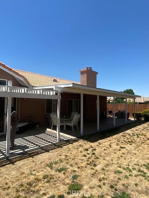 14310 Northstar Ave, Victorville, CA 92392 - back of house with a patio and a chimney
