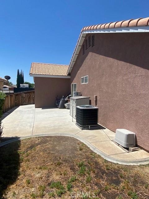 14310 Northstar Ave, Victorville, CA 92392 - back of property with stucco siding, a patio, and a tiled roof