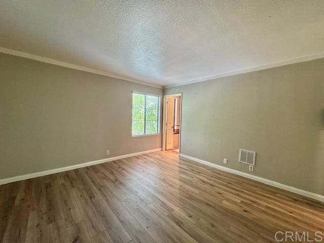 4545 Arizona St Unit 104, San Diego, CA 92116 - unfurnished room featuring wood finished floors, ornamental molding, and a textured ceiling