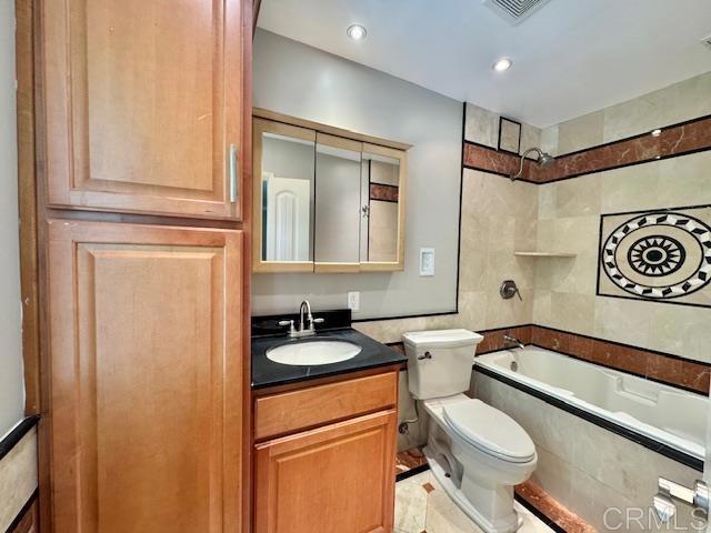 4545 Arizona St Unit 104, San Diego, CA 92116 - bathroom featuring vanity, tub / shower combination, tile walls, and recessed lighting