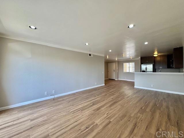 4545 Arizona St Unit 104, San Diego, CA 92116 - unfurnished living room featuring recessed lighting, light wood-style floors, and crown molding