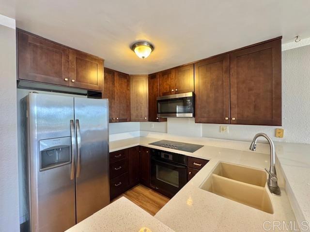 4545 Arizona St Unit 104, San Diego, CA 92116 - kitchen featuring black appliances, light wood-style floors, and light stone countertops