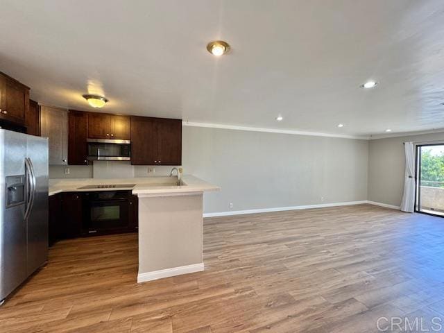 4545 Arizona St Unit 104, San Diego, CA 92116 - kitchen with appliances with stainless steel finishes, light countertops, dark brown cabinetry, light wood finished floors, and recessed lighting