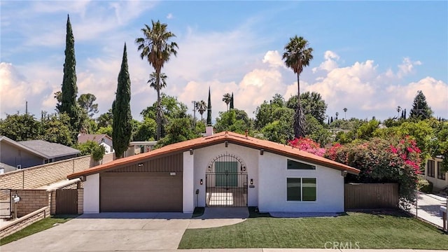 17532 Ludlow St, Granada Hills, CA 91344 - view of front facade with a garage, stucco siding, concrete driveway, and a gate