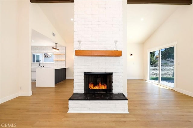 17532 Ludlow St, Granada Hills, CA 91344 - unfurnished living room featuring high vaulted ceiling, a large fireplace, light wood finished floors, and recessed lighting