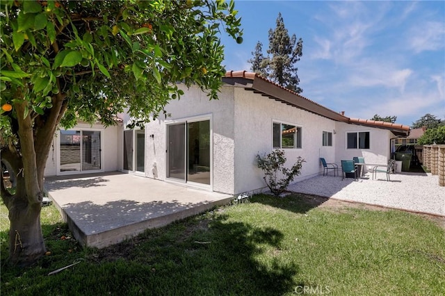 17532 Ludlow St, Granada Hills, CA 91344 - rear view of house featuring a patio, stucco siding, a yard, and a tiled roof