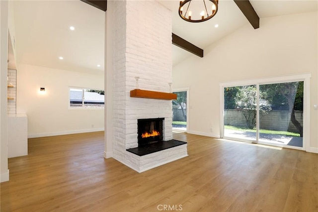 17532 Ludlow St, Granada Hills, CA 91344 - unfurnished living room featuring beam ceiling, a chandelier, wood finished floors, a multi sided fireplace, and high vaulted ceiling