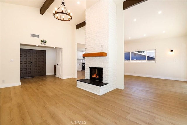 17532 Ludlow St, Granada Hills, CA 91344 - unfurnished living room featuring beamed ceiling, a fireplace, a chandelier, light wood-style flooring, and high vaulted ceiling