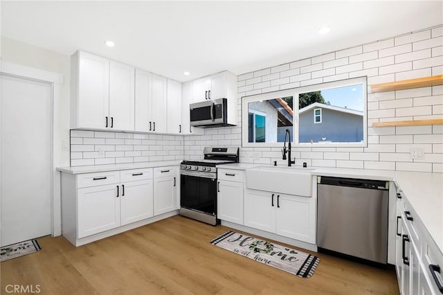 17532 Ludlow St, Granada Hills, CA 91344 - kitchen featuring stainless steel appliances, tasteful backsplash, open shelves, white cabinetry, and recessed lighting