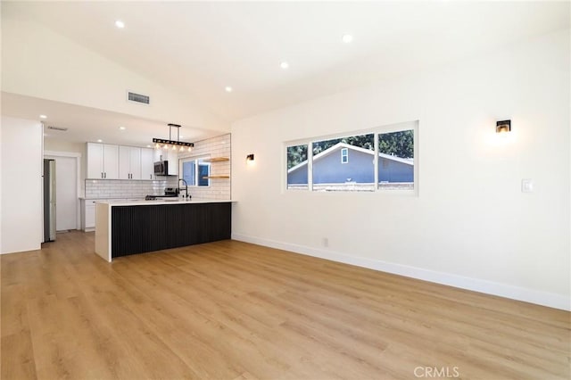 17532 Ludlow St, Granada Hills, CA 91344 - unfurnished living room featuring lofted ceiling, recessed lighting, and light wood-type flooring