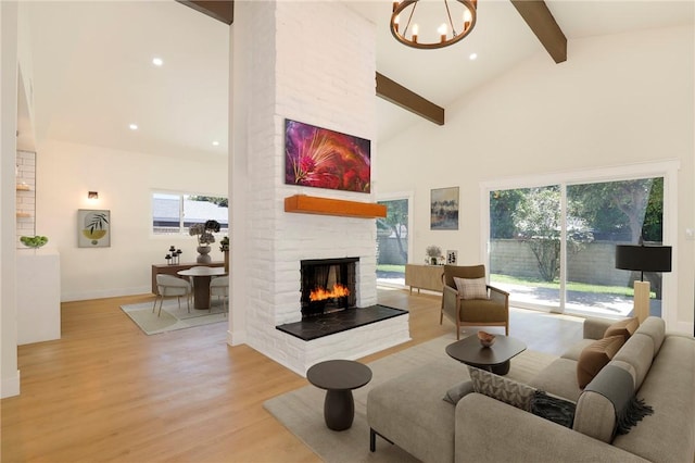 17532 Ludlow St, Granada Hills, CA 91344 - living room featuring beamed ceiling, light wood finished floors, a brick fireplace, a chandelier, and high vaulted ceiling