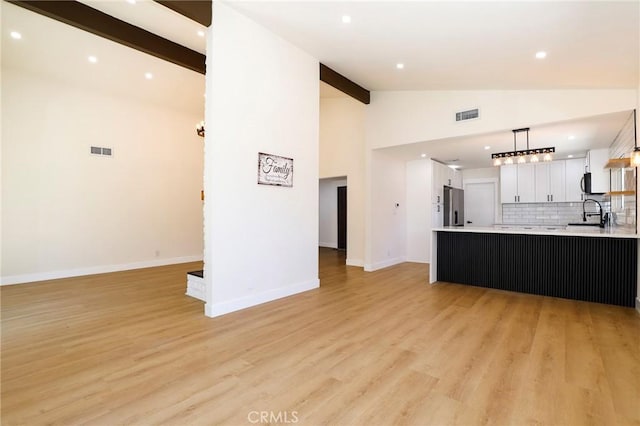 17532 Ludlow St, Granada Hills, CA 91344 - unfurnished living room with beam ceiling, recessed lighting, light wood-style flooring, and high vaulted ceiling