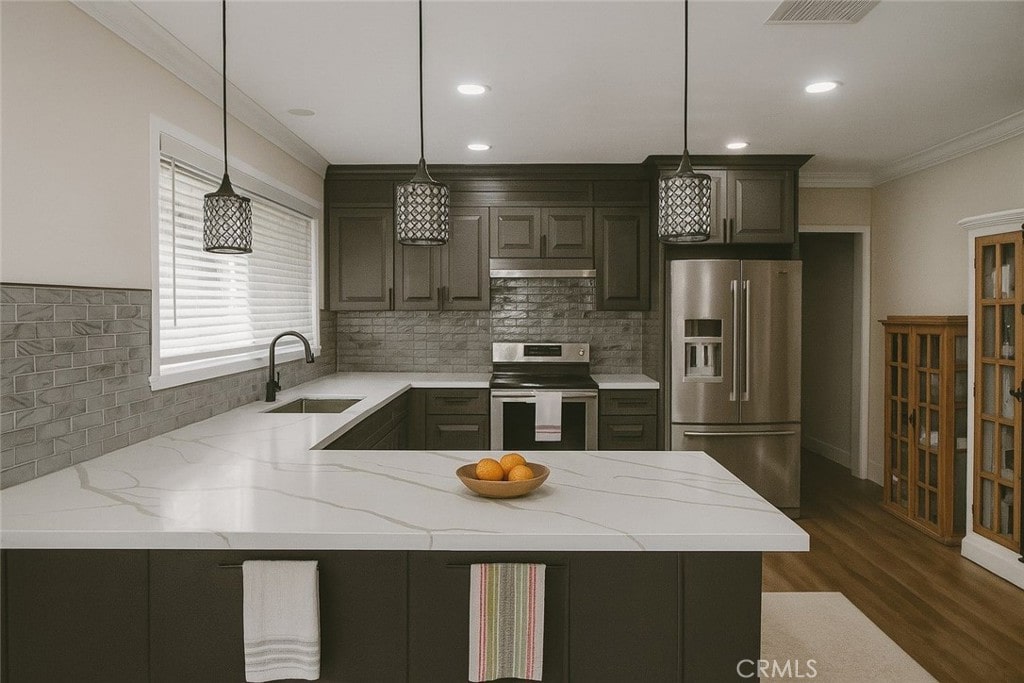 12861 Alamitos Way, Garden Grove, CA 92841 - kitchen featuring stainless steel appliances, ornamental molding, backsplash, dark wood-type flooring, and a peninsula