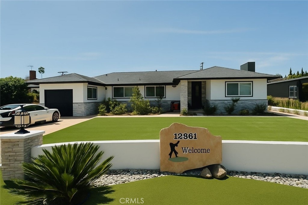 12861 Alamitos Way, Garden Grove, CA 92841 - view of front of house with stone siding, an attached garage, concrete driveway, stucco siding, and a front lawn