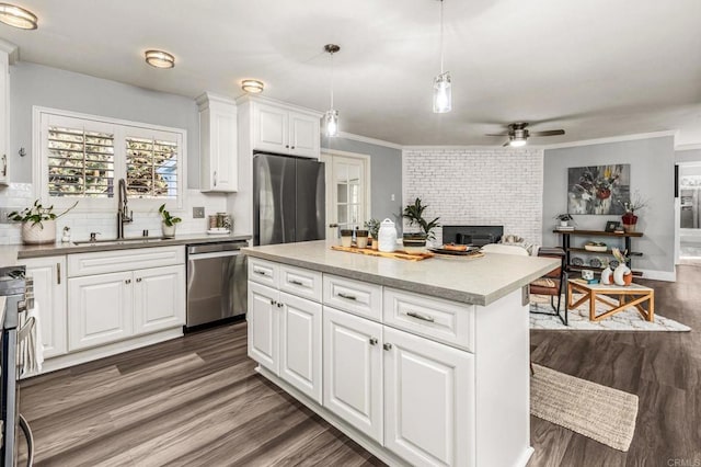1670 Alta Vista Dr, Vista, CA 92084 - kitchen with appliances with stainless steel finishes, dark wood-type flooring, decorative backsplash, a center island, and white cabinets