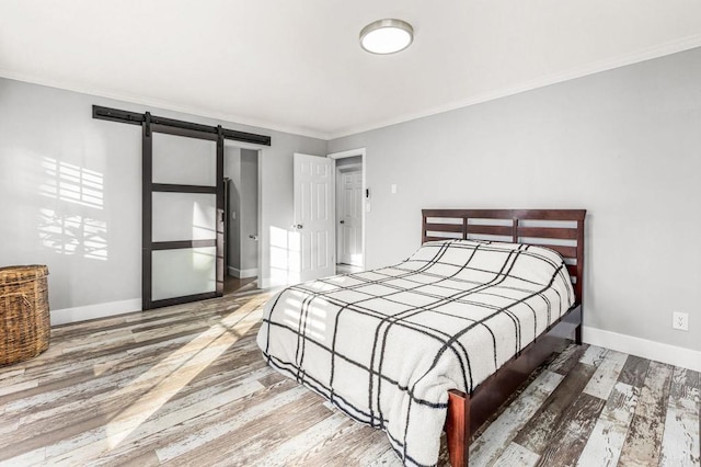 1670 Alta Vista Dr, Vista, CA 92084 - bedroom featuring a barn door, ornamental molding, and wood finished floors